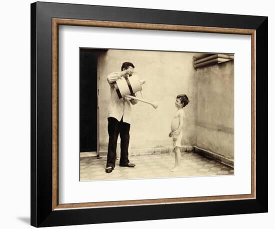 Man Is Sprinkling Boy with Water from Watering Can, 20th Century-Andrew Pitcairn-knowles-Framed Giclee Print