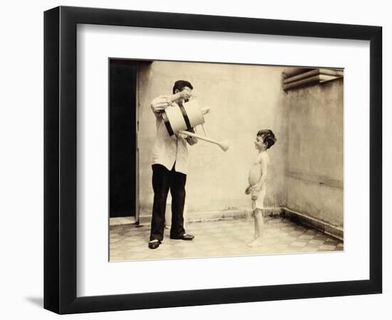 Man Is Sprinkling Boy with Water from Watering Can, 20th Century-Andrew Pitcairn-knowles-Framed Giclee Print