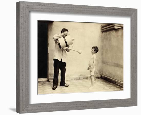 Man Is Sprinkling Boy with Water from Watering Can, 20th Century-Andrew Pitcairn-knowles-Framed Giclee Print