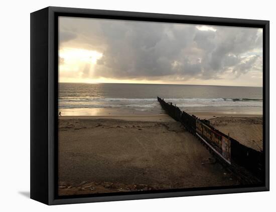 Man Jogs by the Beach Towards the Wall Dividing Mexico and the U.S. in Tijuana, Mexico-null-Framed Premier Image Canvas