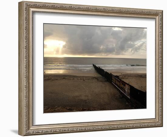 Man Jogs by the Beach Towards the Wall Dividing Mexico and the U.S. in Tijuana, Mexico-null-Framed Photographic Print