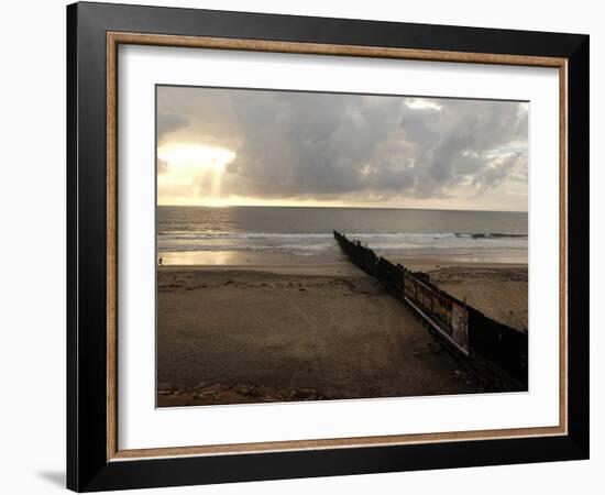 Man Jogs by the Beach Towards the Wall Dividing Mexico and the U.S. in Tijuana, Mexico-null-Framed Photographic Print