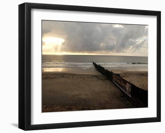 Man Jogs by the Beach Towards the Wall Dividing Mexico and the U.S. in Tijuana, Mexico-null-Framed Photographic Print