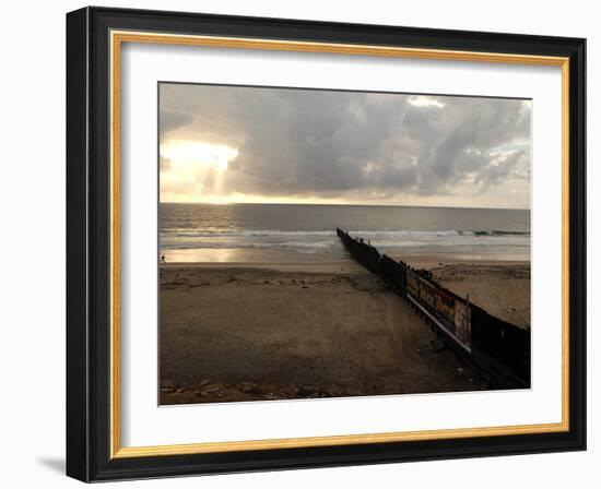 Man Jogs by the Beach Towards the Wall Dividing Mexico and the U.S. in Tijuana, Mexico-null-Framed Photographic Print