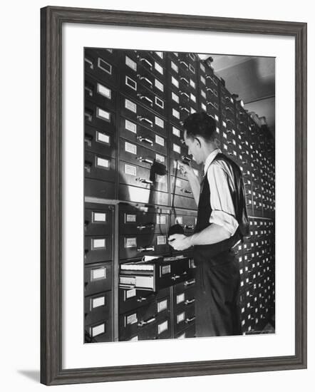 Man Looking at Film Records Containing Social Security Numbers at the Social Security Board-Thomas D^ Mcavoy-Framed Photographic Print