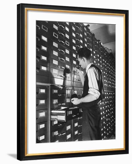 Man Looking at Film Records Containing Social Security Numbers at the Social Security Board-Thomas D^ Mcavoy-Framed Photographic Print