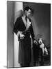 Man Models a Wool Jersey Dressing Gown and His Wire- Haired Fox Terrier Poses for the Camera-null-Mounted Photographic Print