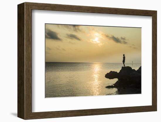 Man on a rock in backlight on the rocky west coast in Ouvea, Loyalty Islands, New Caledonia, Pacifi-Michael Runkel-Framed Photographic Print