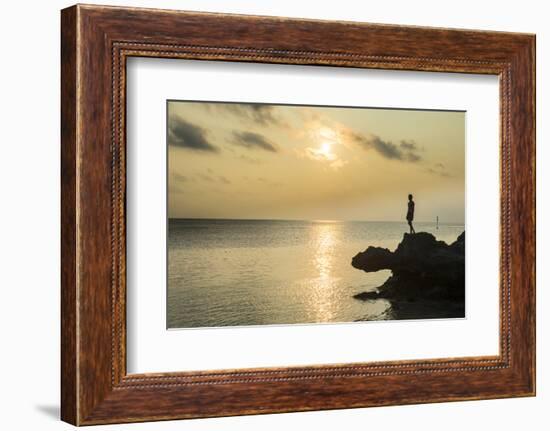 Man on a rock in backlight on the rocky west coast in Ouvea, Loyalty Islands, New Caledonia, Pacifi-Michael Runkel-Framed Photographic Print