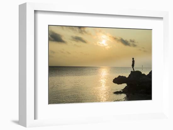 Man on a rock in backlight on the rocky west coast in Ouvea, Loyalty Islands, New Caledonia, Pacifi-Michael Runkel-Framed Photographic Print