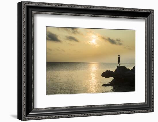 Man on a rock in backlight on the rocky west coast in Ouvea, Loyalty Islands, New Caledonia, Pacifi-Michael Runkel-Framed Photographic Print