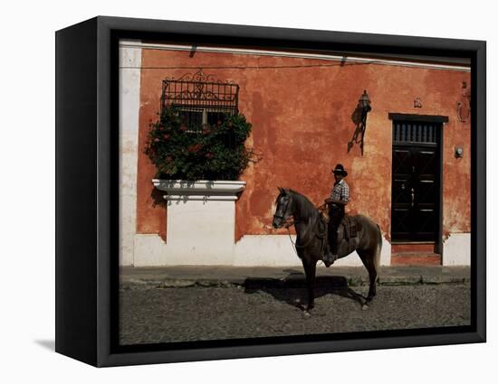 Man on Horse in Front of a Typical Painted Wall, Antigua, Guatemala, Central America-Upperhall-Framed Premier Image Canvas