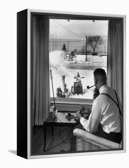 Man Operating Remote Control Snow Plow-Joe Scherschel-Framed Premier Image Canvas