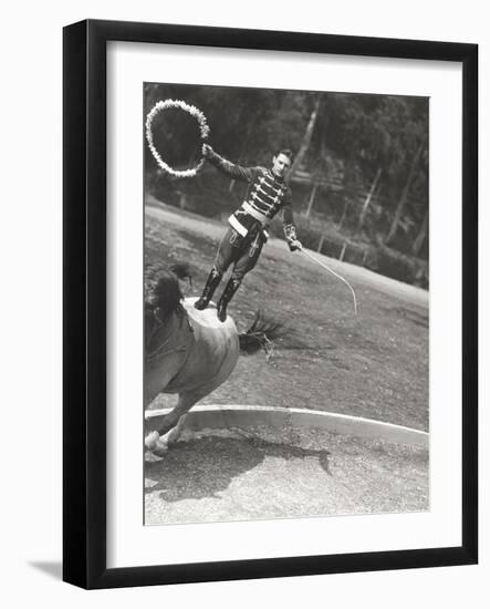 Man Performing Stunt While Standing on Horse--Framed Photo