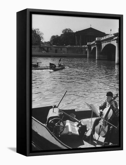 Man Playing Cello on Boat-Loomis Dean-Framed Premier Image Canvas