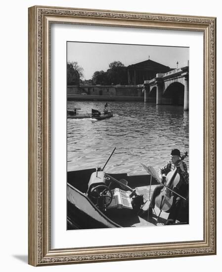 Man Playing Cello on Boat-Loomis Dean-Framed Photographic Print