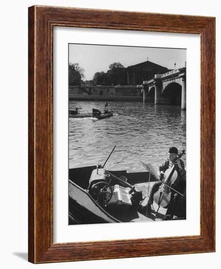 Man Playing Cello on Boat-Loomis Dean-Framed Photographic Print