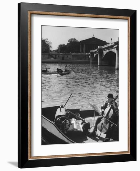 Man Playing Cello on Boat-Loomis Dean-Framed Photographic Print