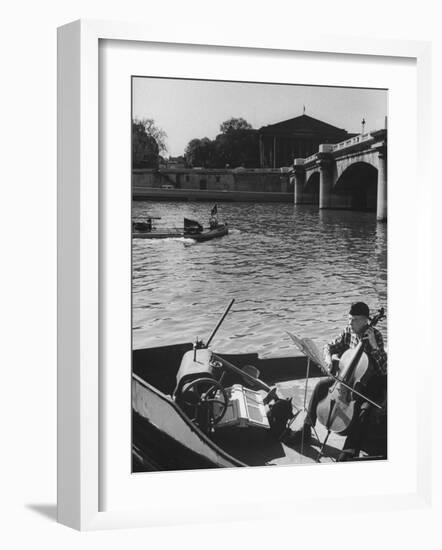 Man Playing Cello on Boat-Loomis Dean-Framed Photographic Print