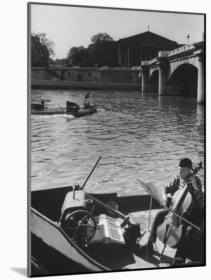 Man Playing Cello on Boat-Loomis Dean-Mounted Photographic Print