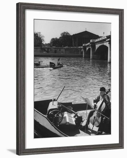 Man Playing Cello on Boat-Loomis Dean-Framed Photographic Print