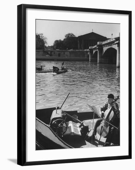 Man Playing Cello on Boat-Loomis Dean-Framed Photographic Print