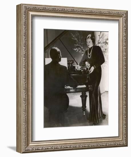 Man Plays a Piano and Looks up at a Glamorous Woman in a Long Dress-null-Framed Photographic Print