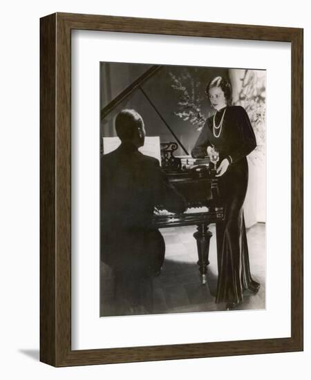 Man Plays a Piano and Looks up at a Glamorous Woman in a Long Dress-null-Framed Photographic Print