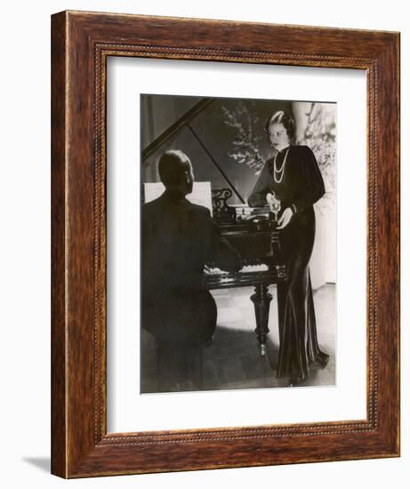 Man Plays a Piano and Looks up at a Glamorous Woman in a Long Dress-null-Framed Photographic Print