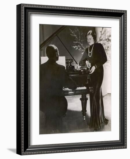 Man Plays a Piano and Looks up at a Glamorous Woman in a Long Dress-null-Framed Photographic Print