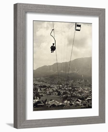 Man Riding Chair Lift Above Town-Jerry Cooke-Framed Photographic Print