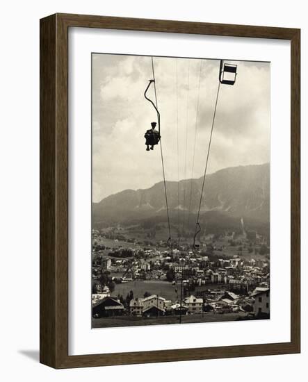 Man Riding Chair Lift Above Town-Jerry Cooke-Framed Photographic Print