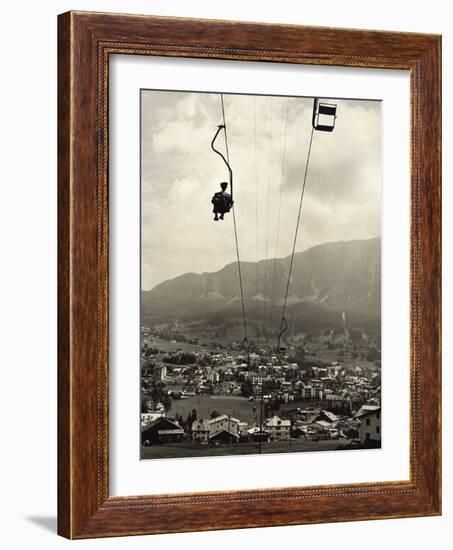 Man Riding Chair Lift Above Town-Jerry Cooke-Framed Photographic Print