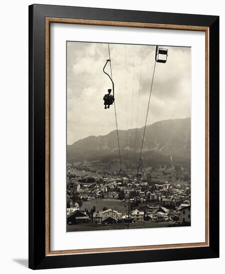 Man Riding Chair Lift Above Town-Jerry Cooke-Framed Photographic Print