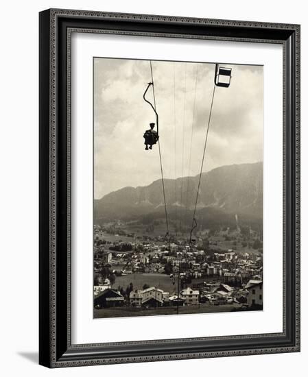 Man Riding Chair Lift Above Town-Jerry Cooke-Framed Photographic Print