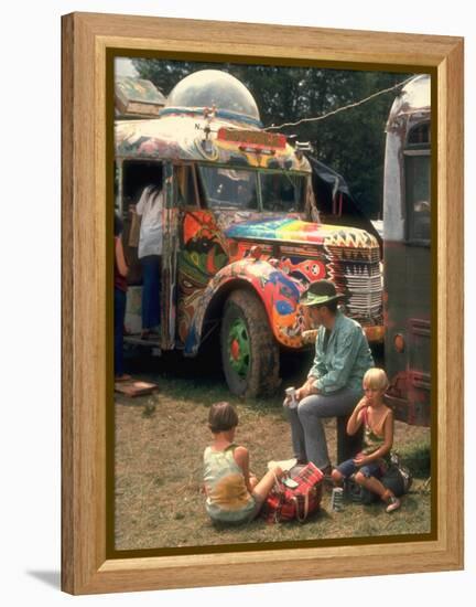 Man Seated with Two Young Boys in Front of a Wildly Painted School Bus, Woodstock Music Art Fest-John Dominis-Framed Premier Image Canvas