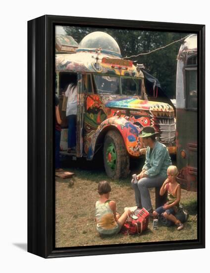 Man Seated with Two Young Boys in Front of a Wildly Painted School Bus, Woodstock Music Art Fest-John Dominis-Framed Premier Image Canvas