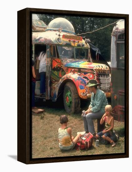 Man Seated with Two Young Boys in Front of a Wildly Painted School Bus, Woodstock Music Art Fest-John Dominis-Framed Premier Image Canvas