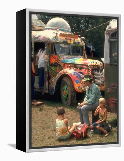 Man Seated with Two Young Boys in Front of a Wildly Painted School Bus, Woodstock Music Art Fest-John Dominis-Framed Premier Image Canvas