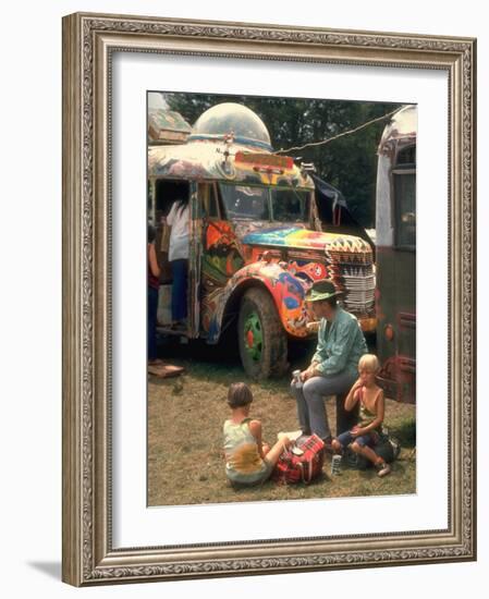 Man Seated with Two Young Boys in Front of a Wildly Painted School Bus, Woodstock Music Art Fest-John Dominis-Framed Photographic Print