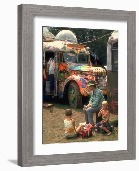 Man Seated with Two Young Boys in Front of a Wildly Painted School Bus, Woodstock Music Art Fest-John Dominis-Framed Photographic Print