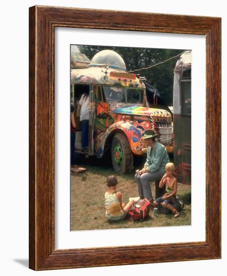 Man Seated with Two Young Boys in Front of a Wildly Painted School Bus, Woodstock Music Art Fest-John Dominis-Framed Photographic Print