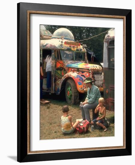 Man Seated with Two Young Boys in Front of a Wildly Painted School Bus, Woodstock Music Art Fest-John Dominis-Framed Photographic Print