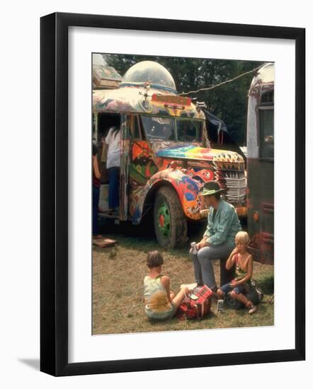 Man Seated with Two Young Boys in Front of a Wildly Painted School Bus, Woodstock Music Art Fest-John Dominis-Framed Photographic Print