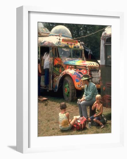 Man Seated with Two Young Boys in Front of a Wildly Painted School Bus, Woodstock Music Art Fest-John Dominis-Framed Photographic Print