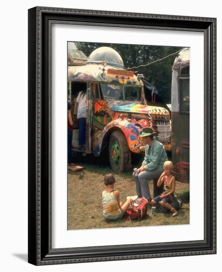 Man Seated with Two Young Boys in Front of a Wildly Painted School Bus, Woodstock Music Art Fest-John Dominis-Framed Photographic Print