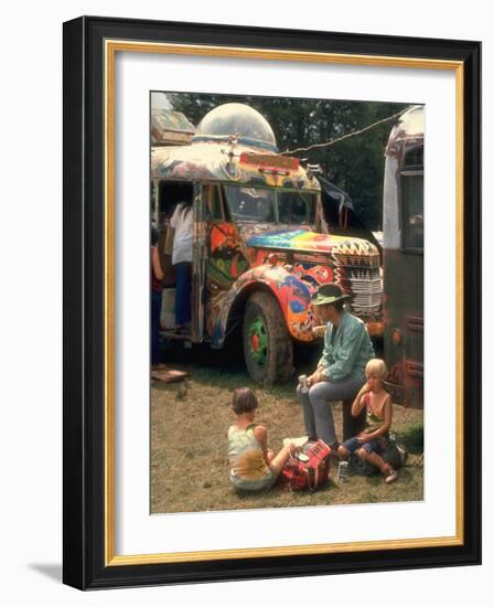 Man Seated with Two Young Boys in Front of a Wildly Painted School Bus, Woodstock Music Art Fest-John Dominis-Framed Photographic Print