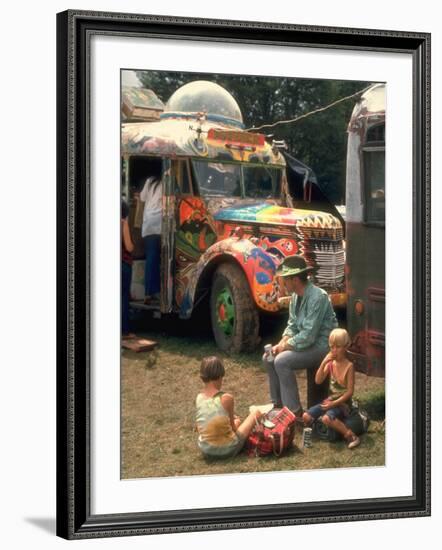 Man Seated with Two Young Boys in Front of a Wildly Painted School Bus, Woodstock Music Art Fest-John Dominis-Framed Photographic Print