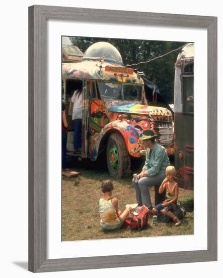 Man Seated with Two Young Boys in Front of a Wildly Painted School Bus, Woodstock Music Art Fest-John Dominis-Framed Photographic Print