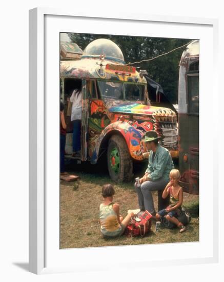 Man Seated with Two Young Boys in Front of a Wildly Painted School Bus, Woodstock Music Art Fest-John Dominis-Framed Photographic Print